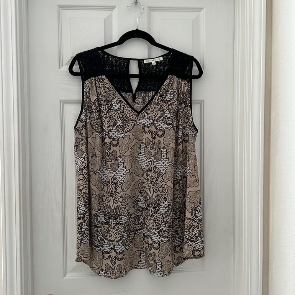 Sleeveless top with black lace on shoulders and back.